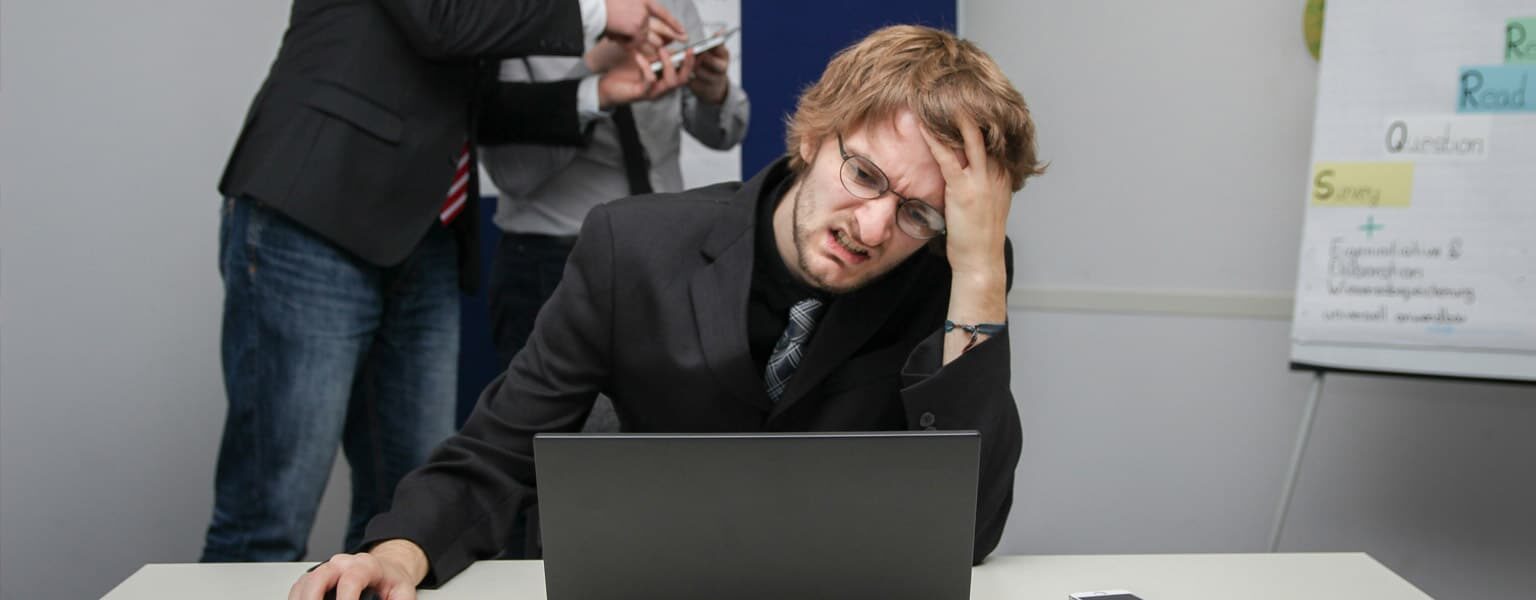 A frustrated office worker on a computer