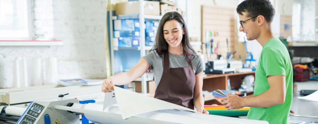 Man helping an art school student with managed print services