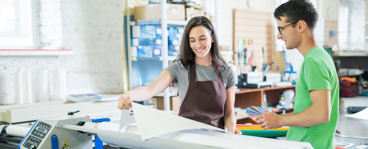 Man helping an art school student with managed print services