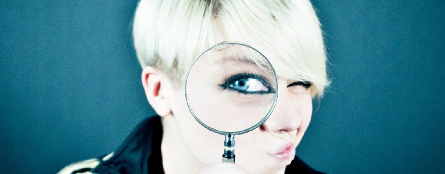 How to Identify a Phishing Email Woman with a magnifying glass